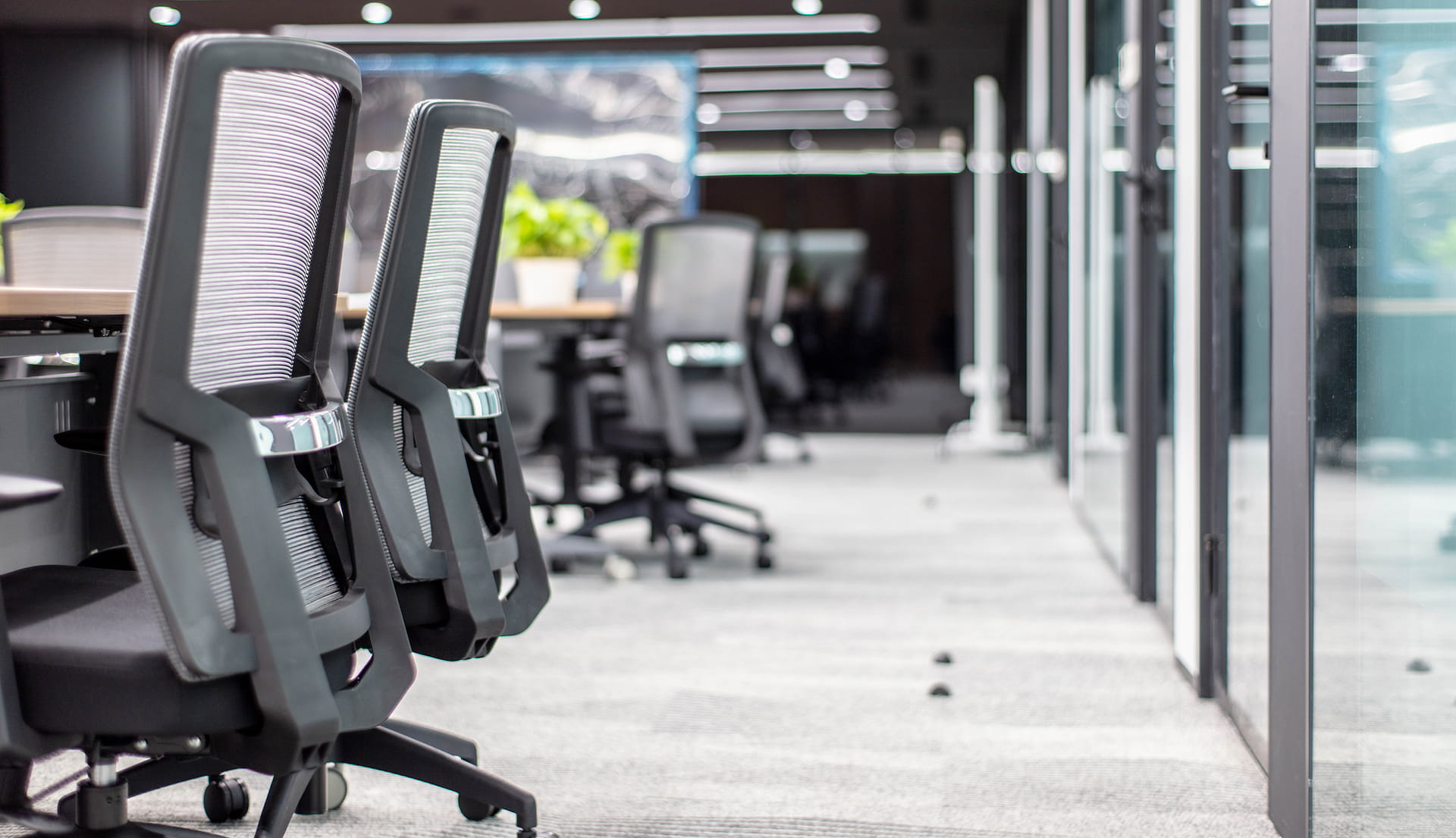 Modern office floor with desks and glass partitions